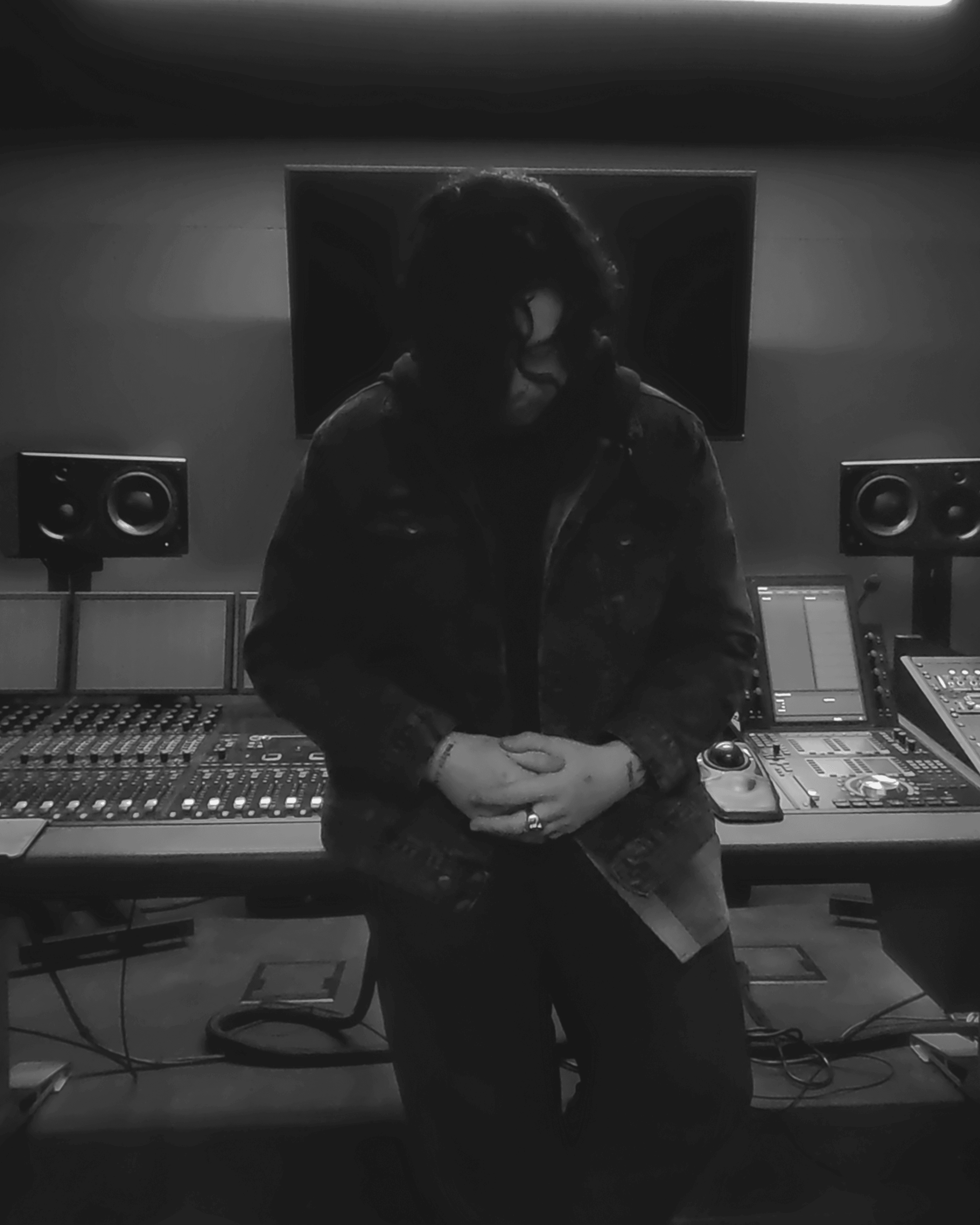James Laurent seated at an audio production console.